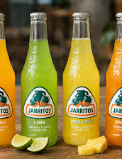 Bottles of Jarritos Mexican soda in lime, pineapple, and mandarin flavors